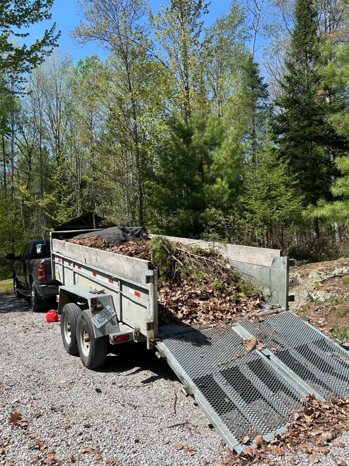 Trailer loaded with brush and debris, ready to haul away